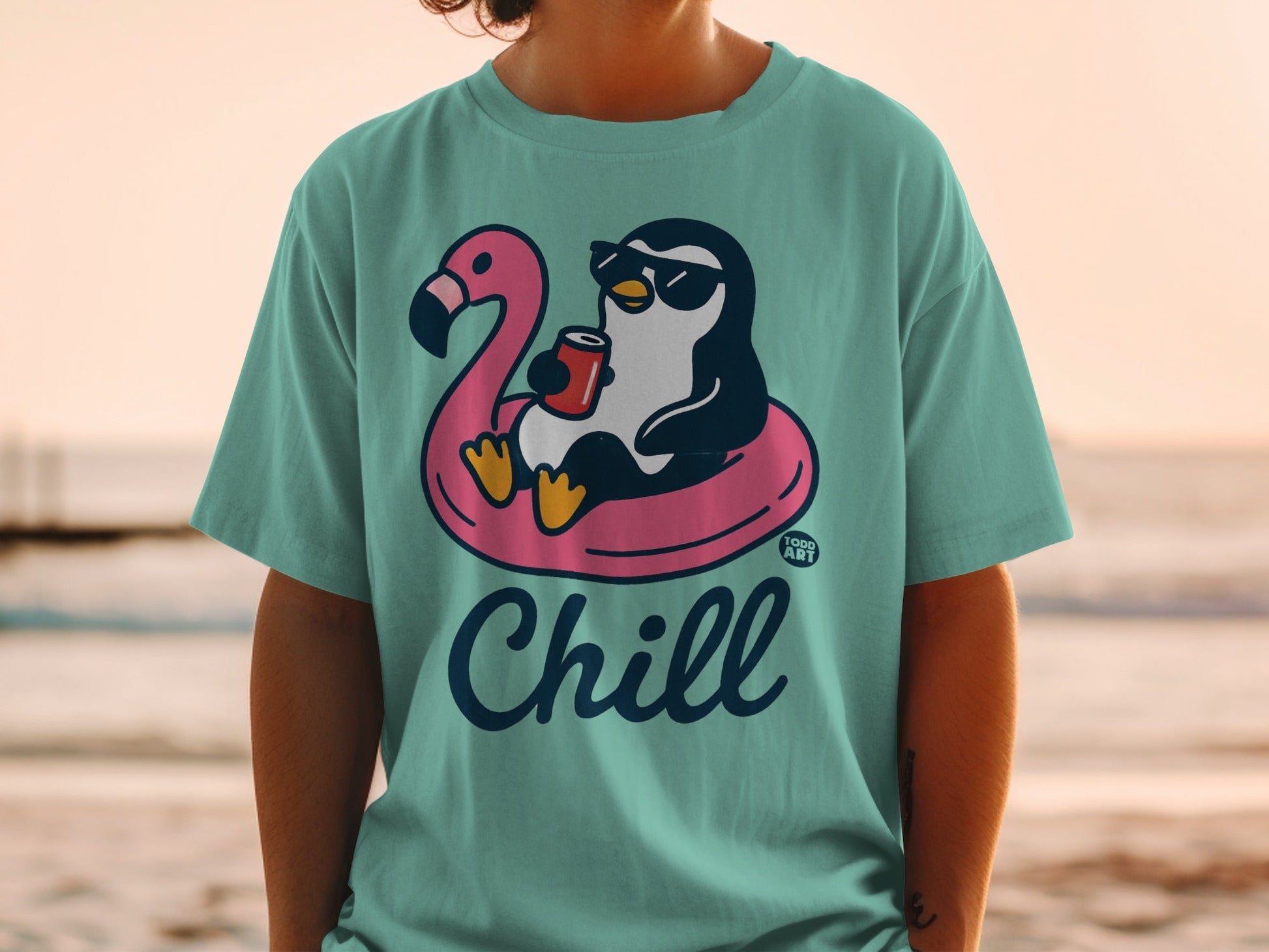 Penguin wearing sunglasses on a flamingo float holding a drink, "Chill" text.