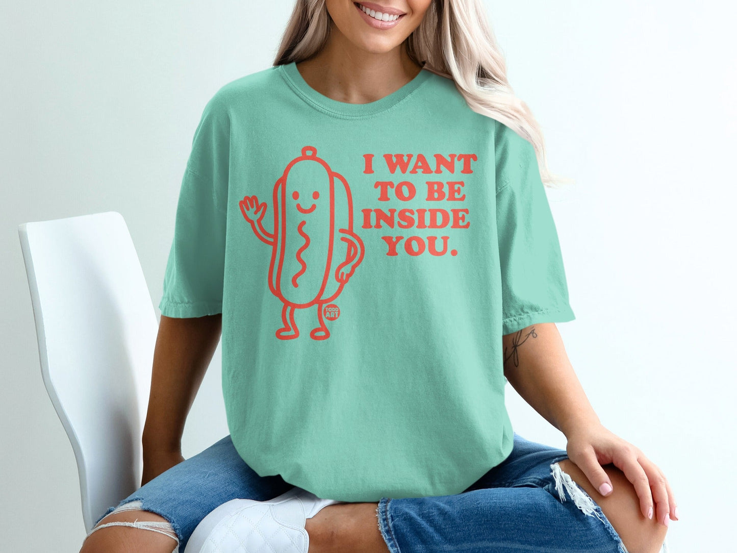 Mint green t-shirt with a cartoon hot dog graphic and "I WANT TO BE INSIDE YOU." text.