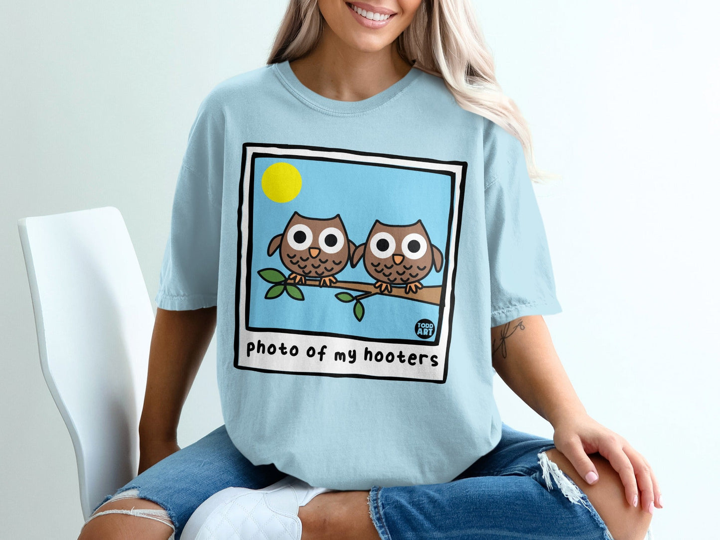 Two cartoon owls on a branch in a framed photo, text "photo of my hooters".