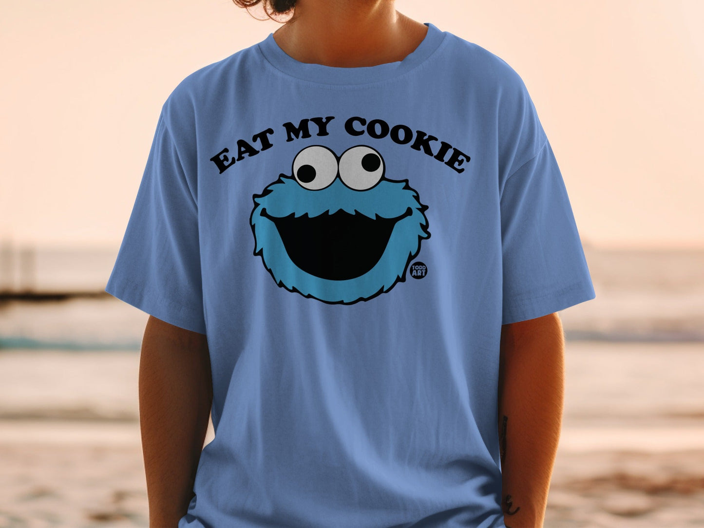 Blue t-shirt with Cookie Monster graphic and "EAT MY COOKIE" text.
