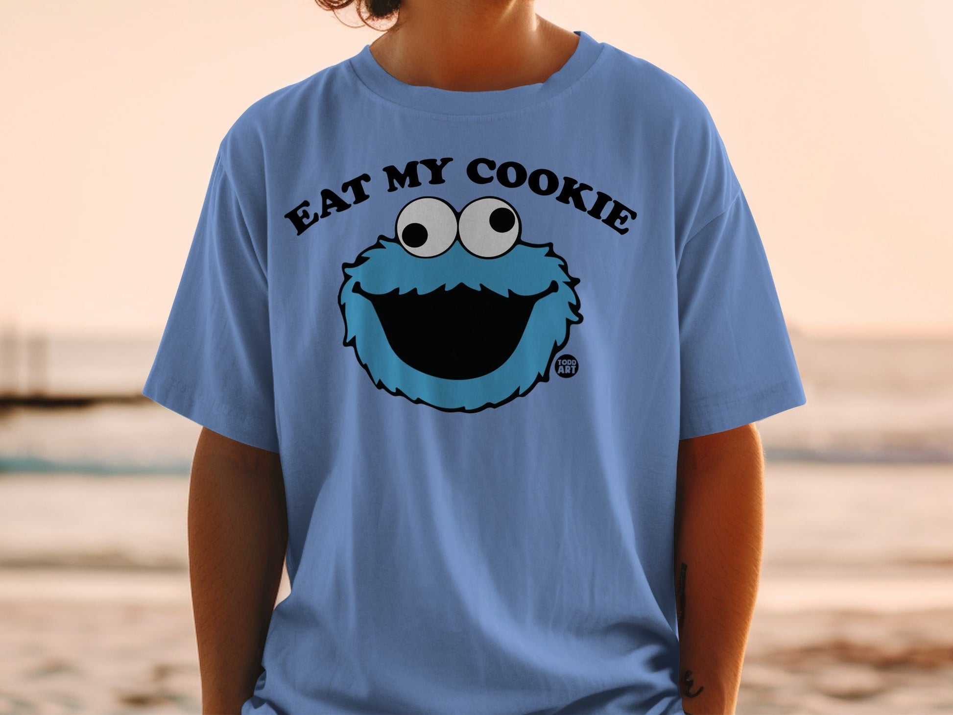 Blue t-shirt with Cookie Monster graphic and "EAT MY COOKIE" text.