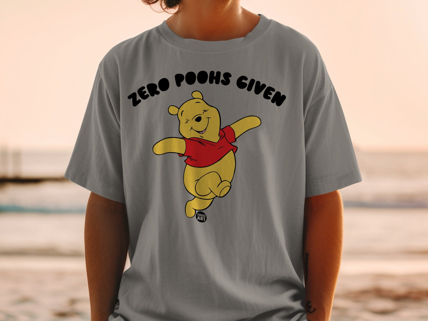 Winnie the Pooh graphic tee with "Zero Poohs Given" text.
