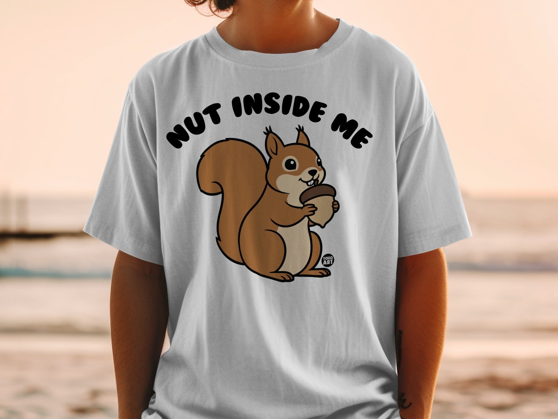 T-shirt with a cartoon squirrel holding a nut, text reads "NUT INSIDE ME".