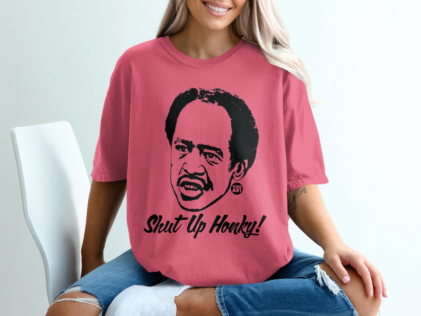 Pink t-shirt with portrait of Redd Foxx and "Shut Up Honky!" text.