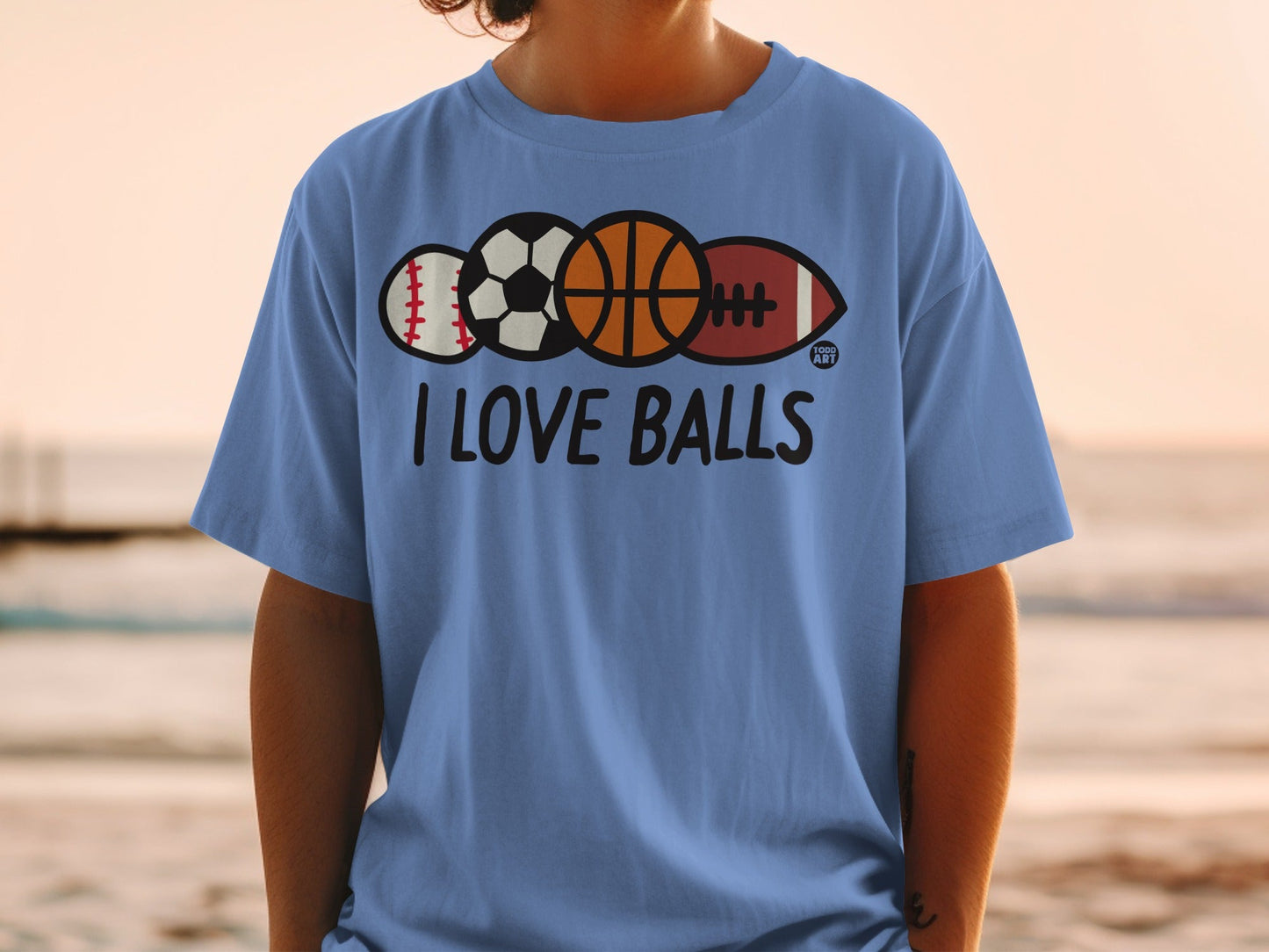 Light blue t-shirt with balls and "I LOVE BALLS" text.