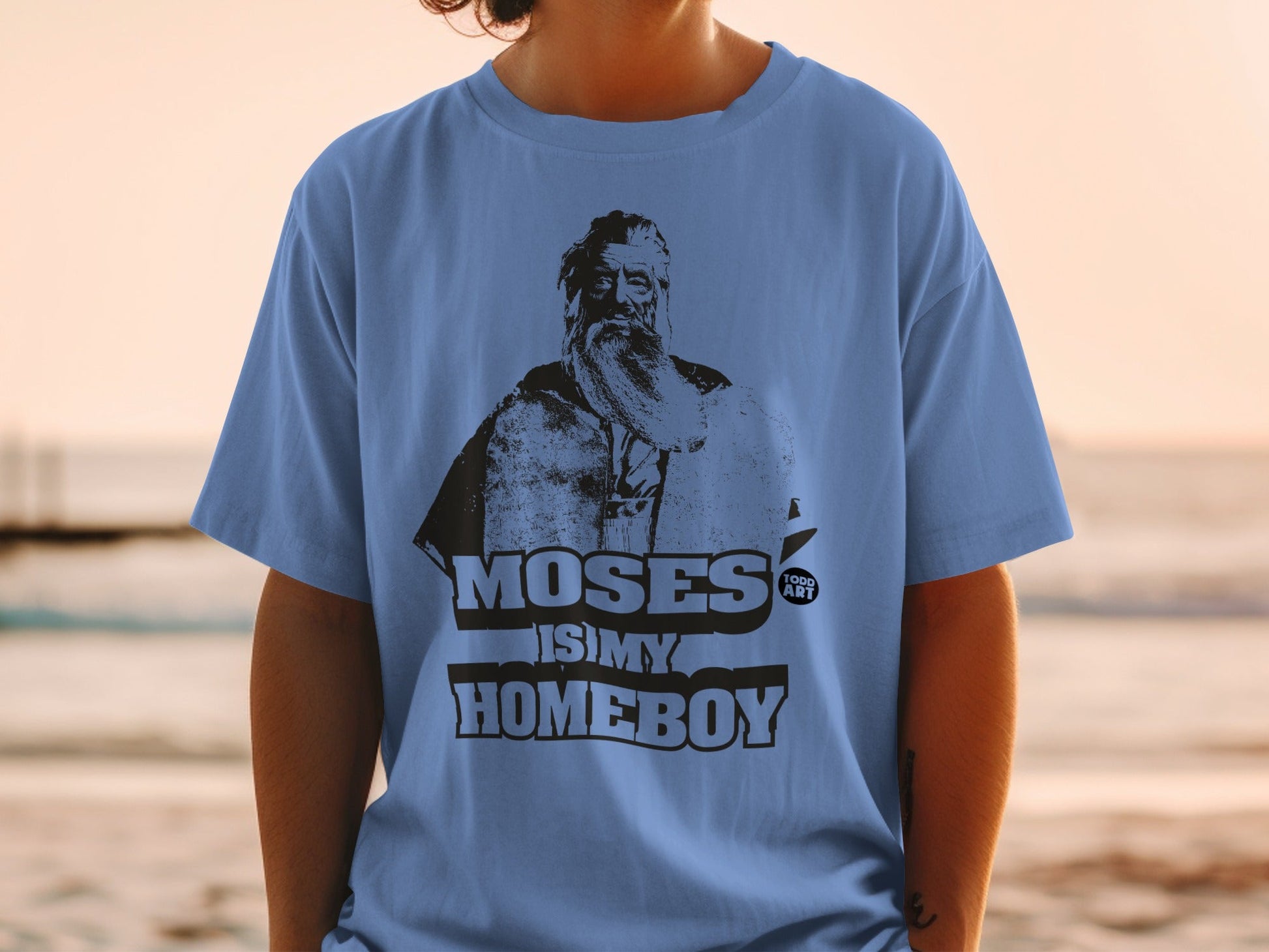 Blue t-shirt with black graphic of Moses and text "MOSES IS MY HOMEBOY".
