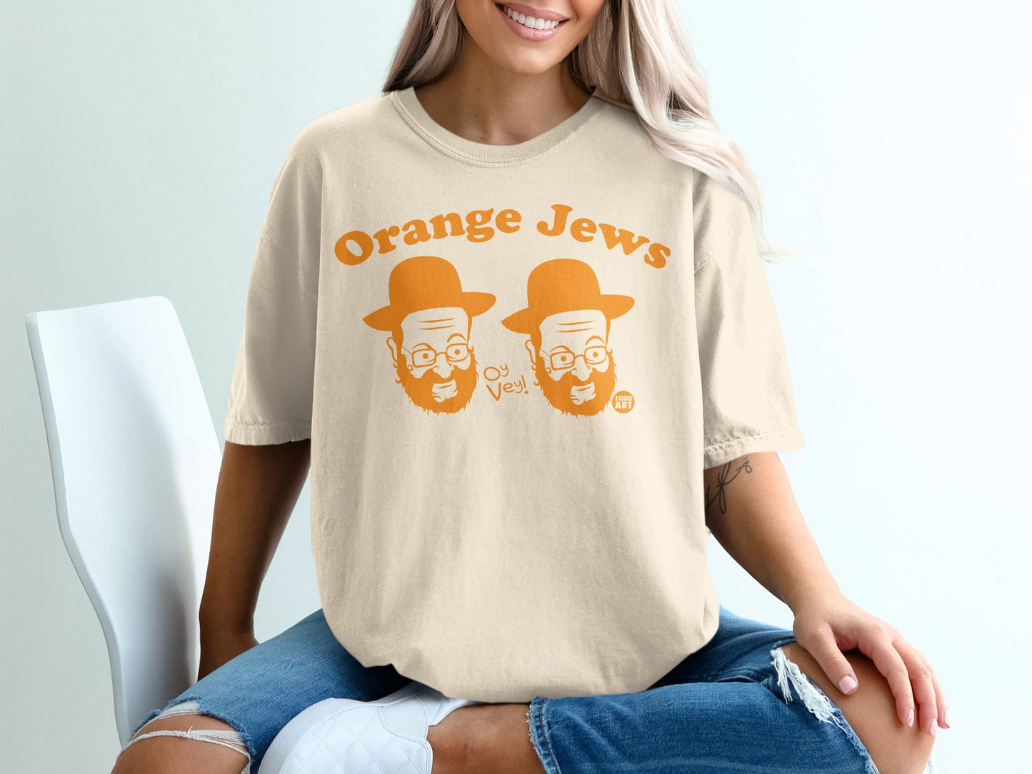 Cream t-shirt with cartoon faces and "Orange Jews Oy Vey!" text.