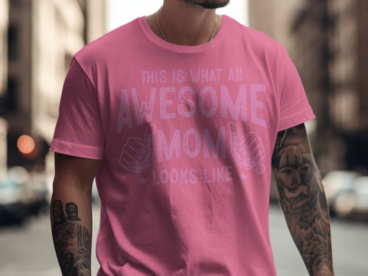 Pink t-shirt with text "This Is What An Awesome Mom Looks Like" and hand graphics.