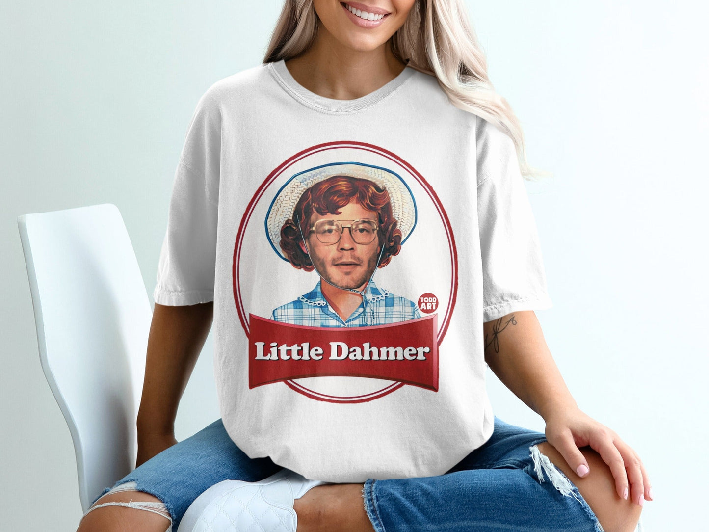 White t-shirt with "Little Dahmer" text and portrait of a man in a hat.