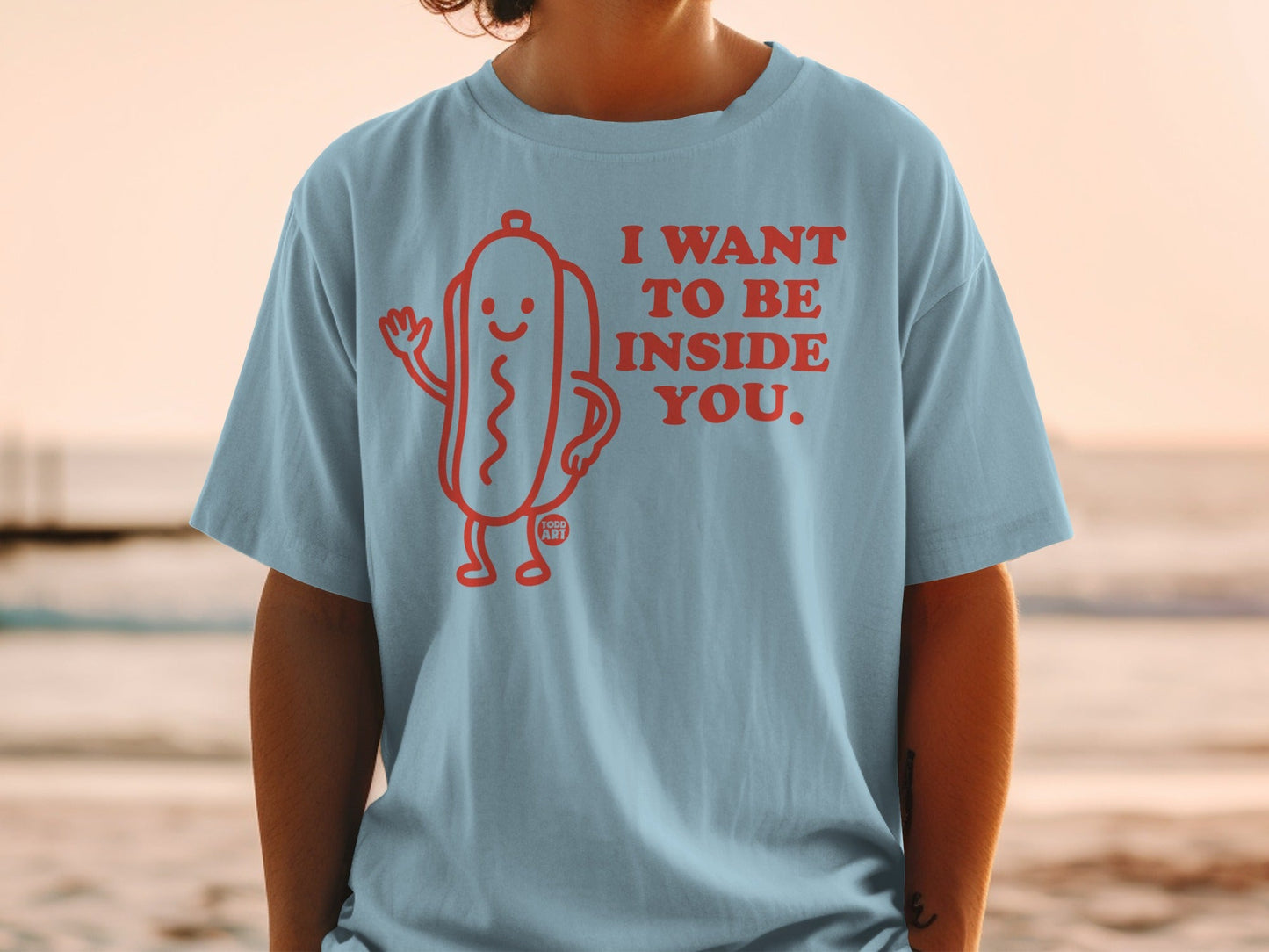 T-shirt with a smiling hot dog graphic and text "I want to be inside you."