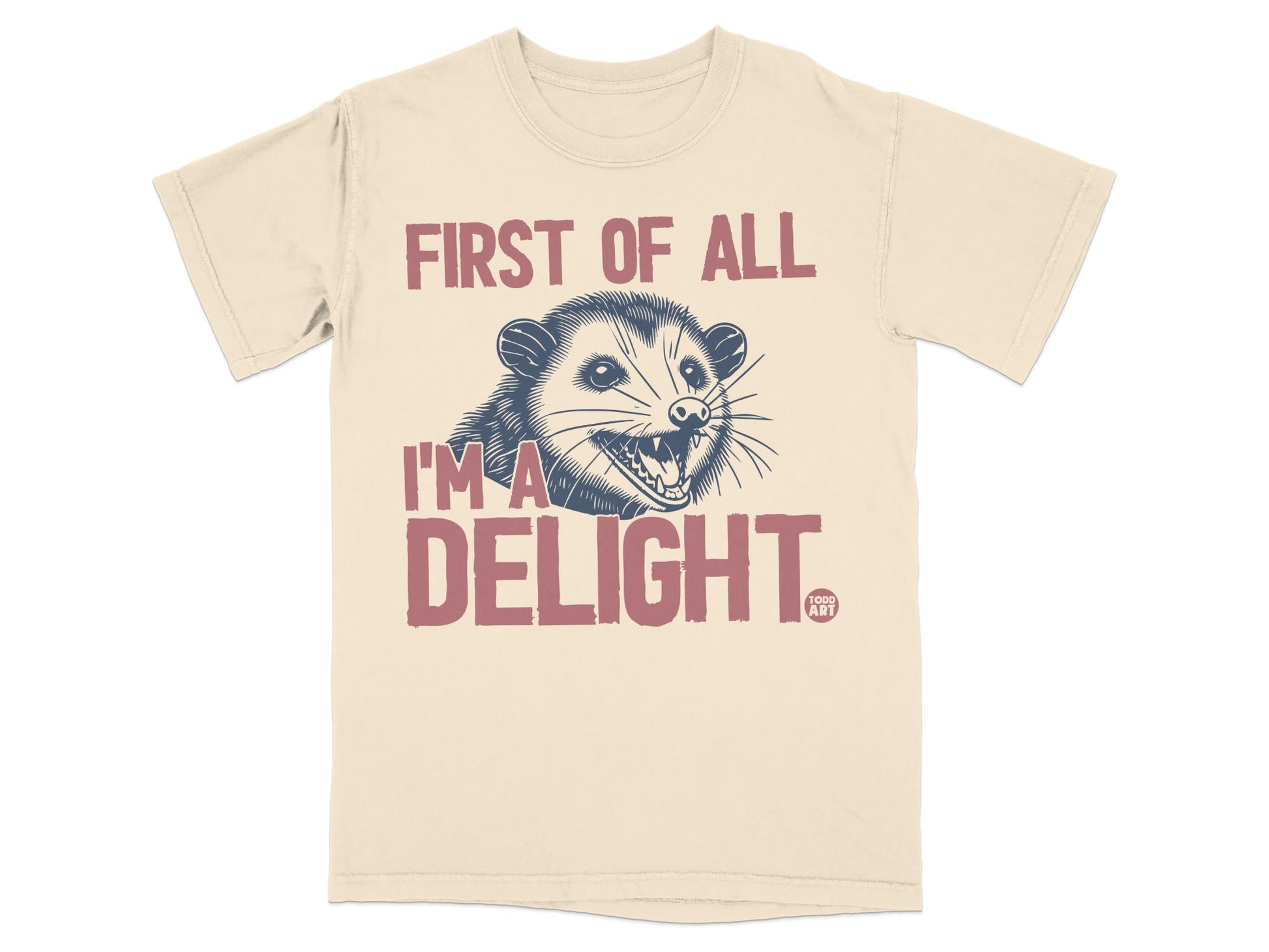 Cream t-shirt with an opossum and text "First of all, I'm a DELIGHT."