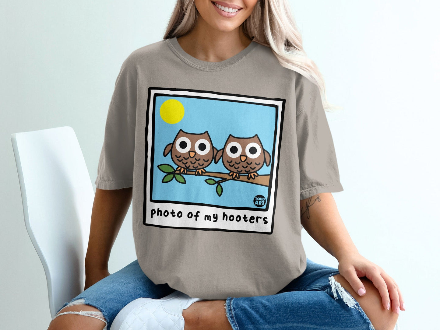 Two cartoon owls on a branch with a sun, "photo of my hooters" text.