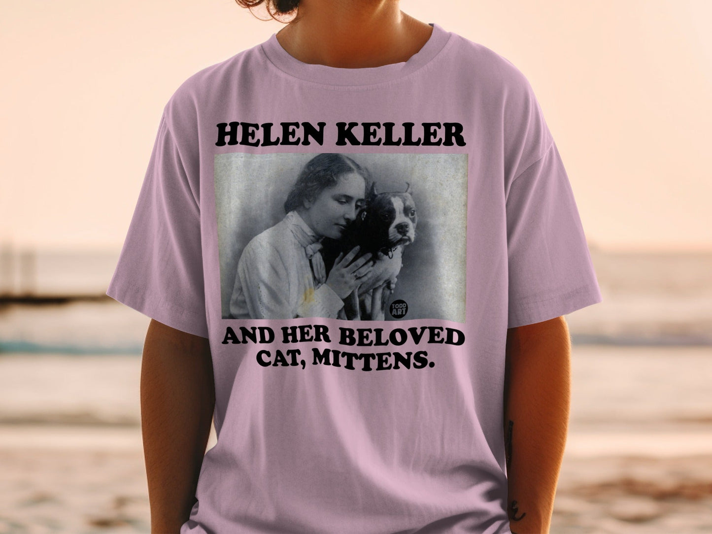 HELEN KELLER AND HER CAT, MITTENS. vintage portrait on a pink t-shirt.