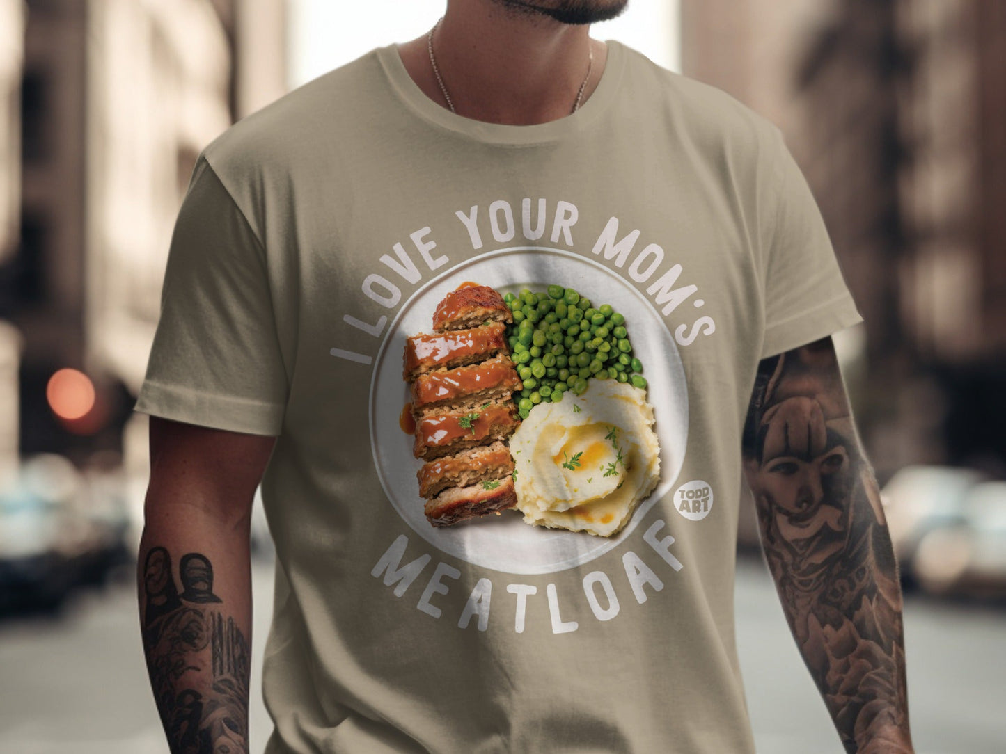 T-shirt with "I Love Your Mom's Meatloaf" text and meatloaf, mashed potatoes, and peas graphic.