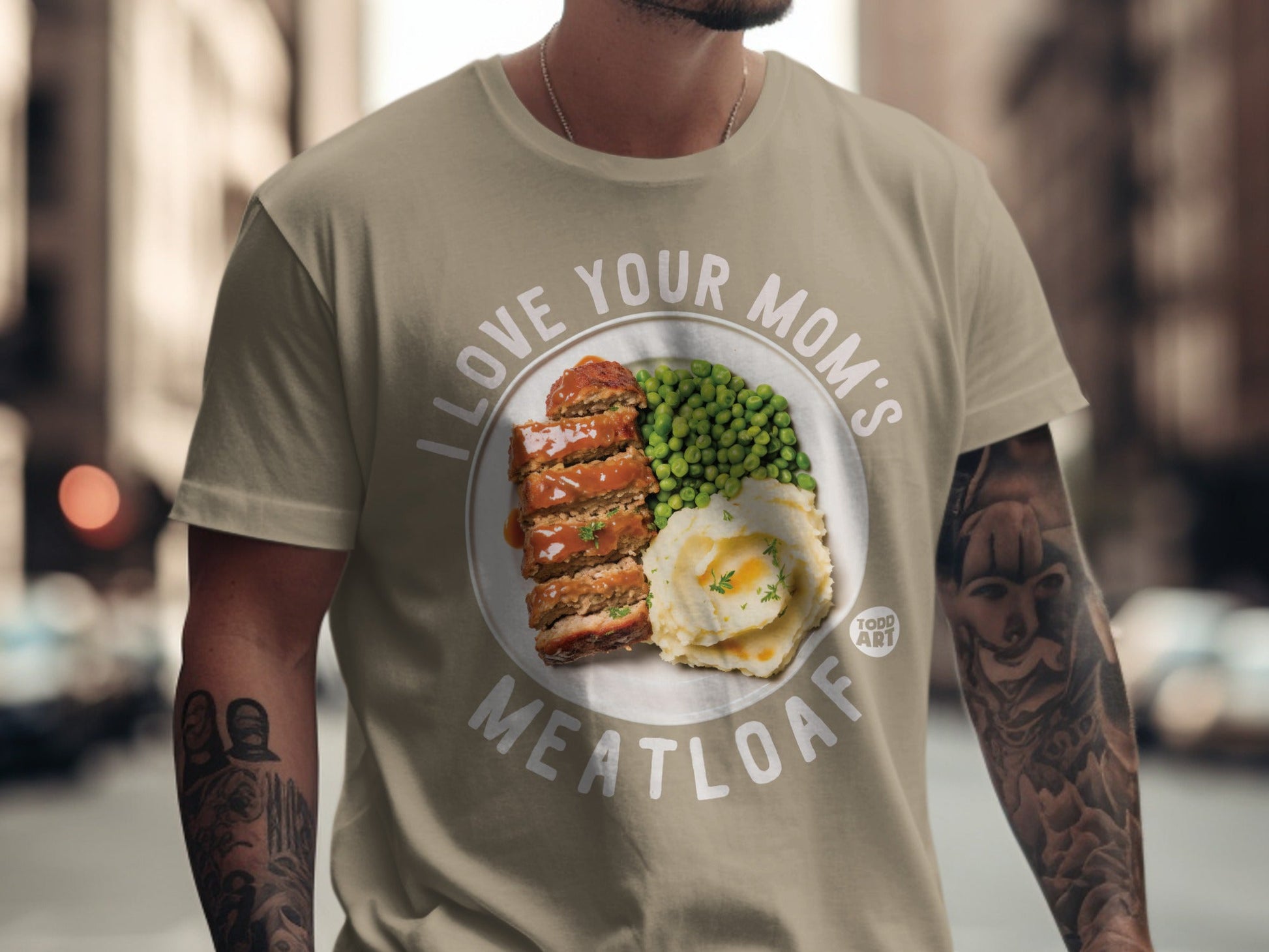 T-shirt with "I Love Your Mom's Meatloaf" text and meatloaf, mashed potatoes, and peas graphic.