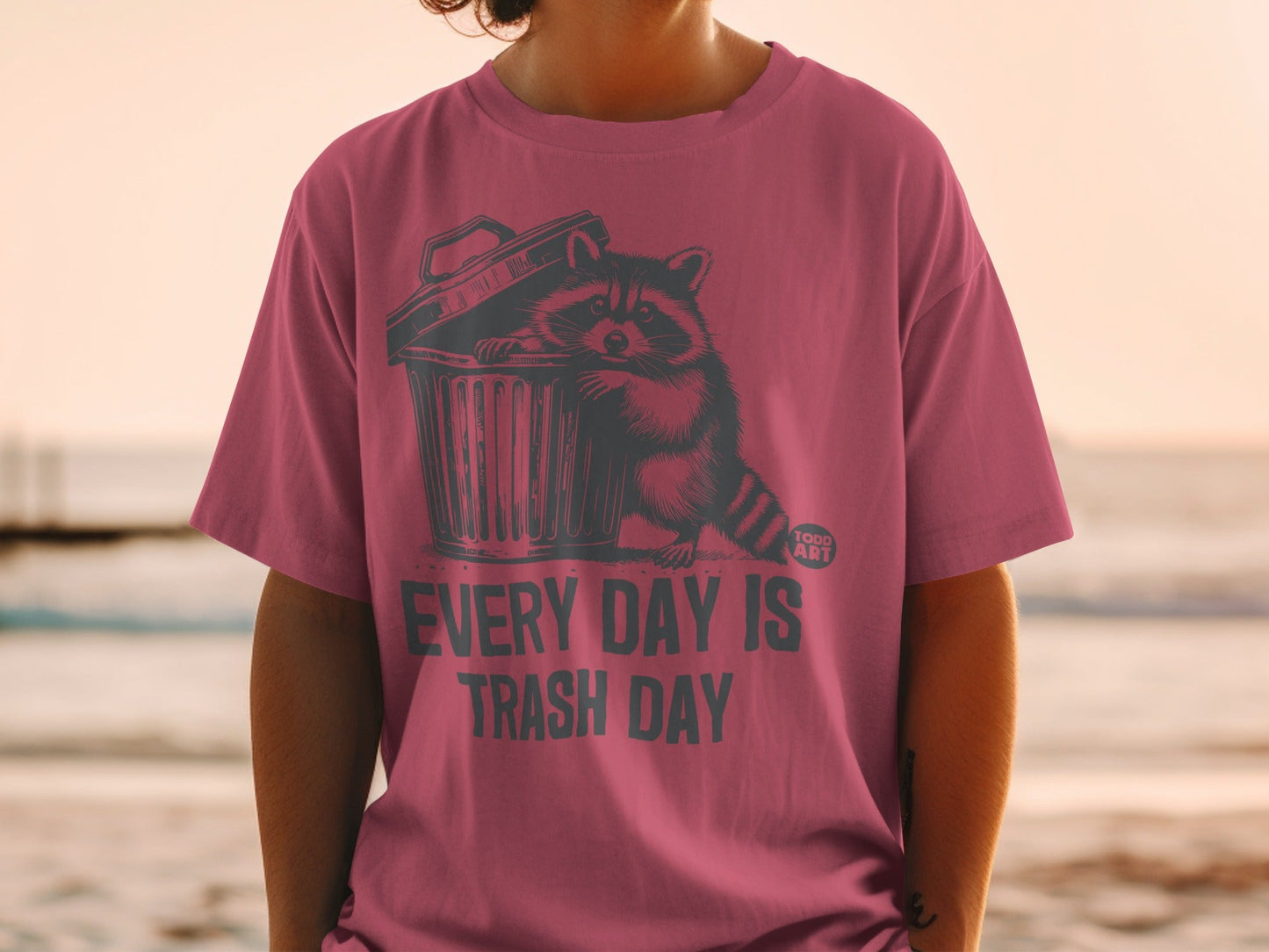 T-shirt with raccoon in trash can graphic and text "EVERY DAY IS TRASH DAY".
