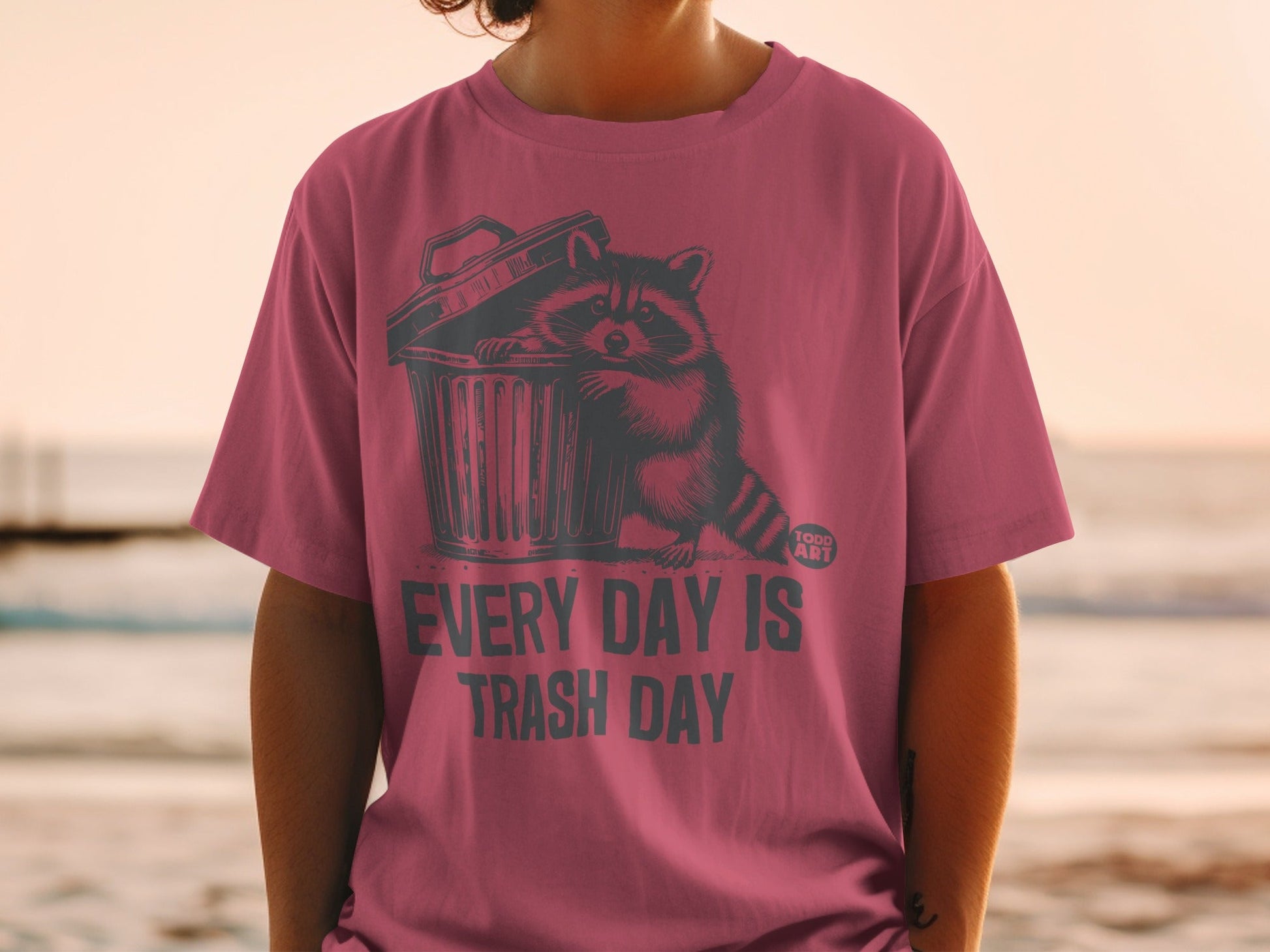 T-shirt with raccoon in trash can graphic and text "EVERY DAY IS TRASH DAY".