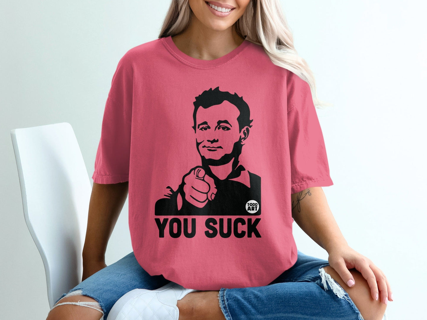T-shirt with graphic of man pointing and text "YOU SUCK".