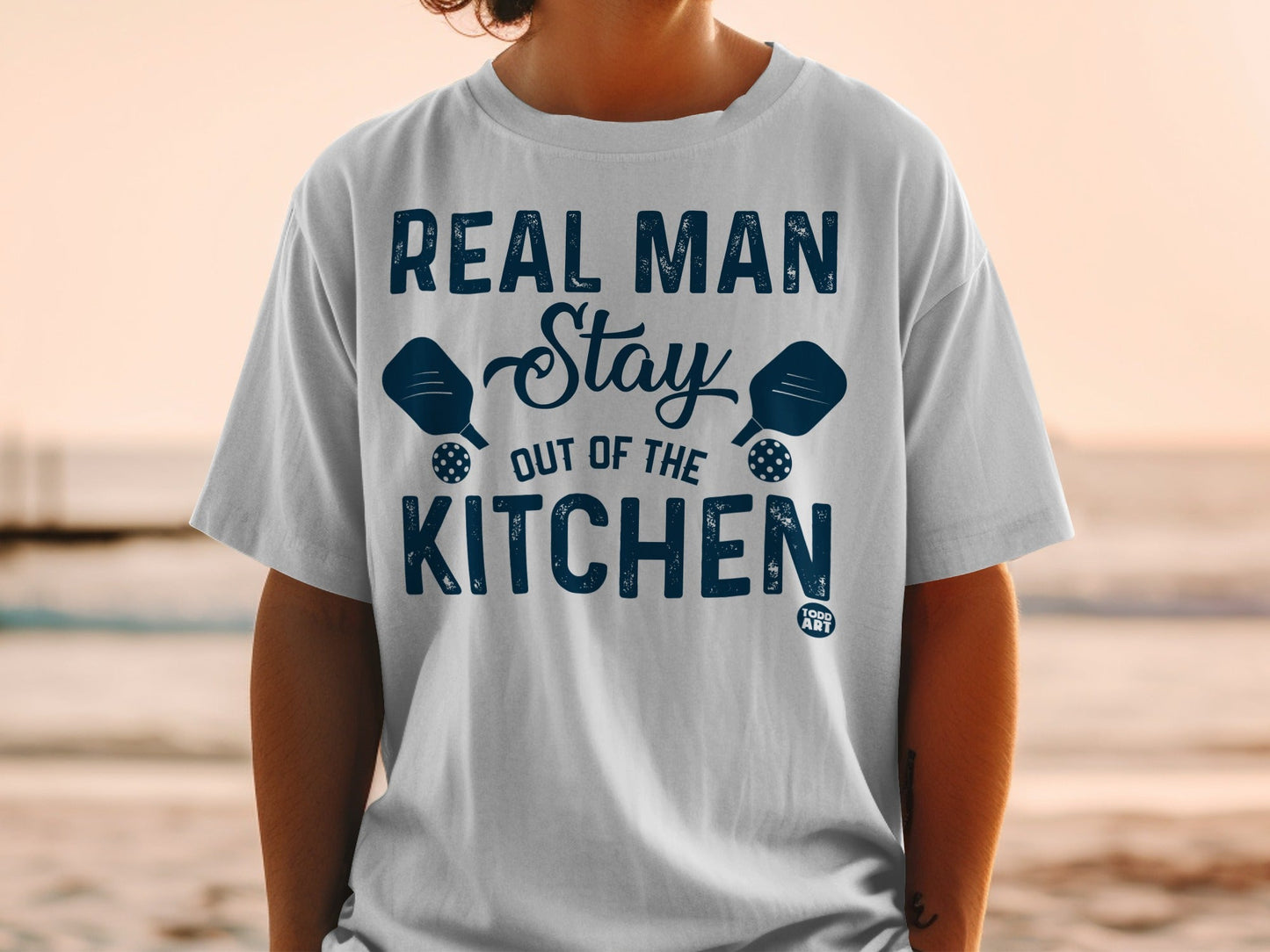 Real Man Stay Out Of The Kitchen pickleball graphic t-shirt.