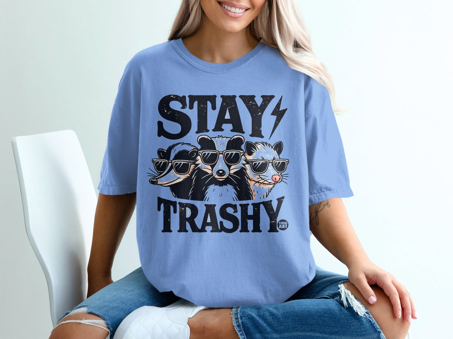 Three raccoons wearing sunglasses with "STAY TRASHY" text.