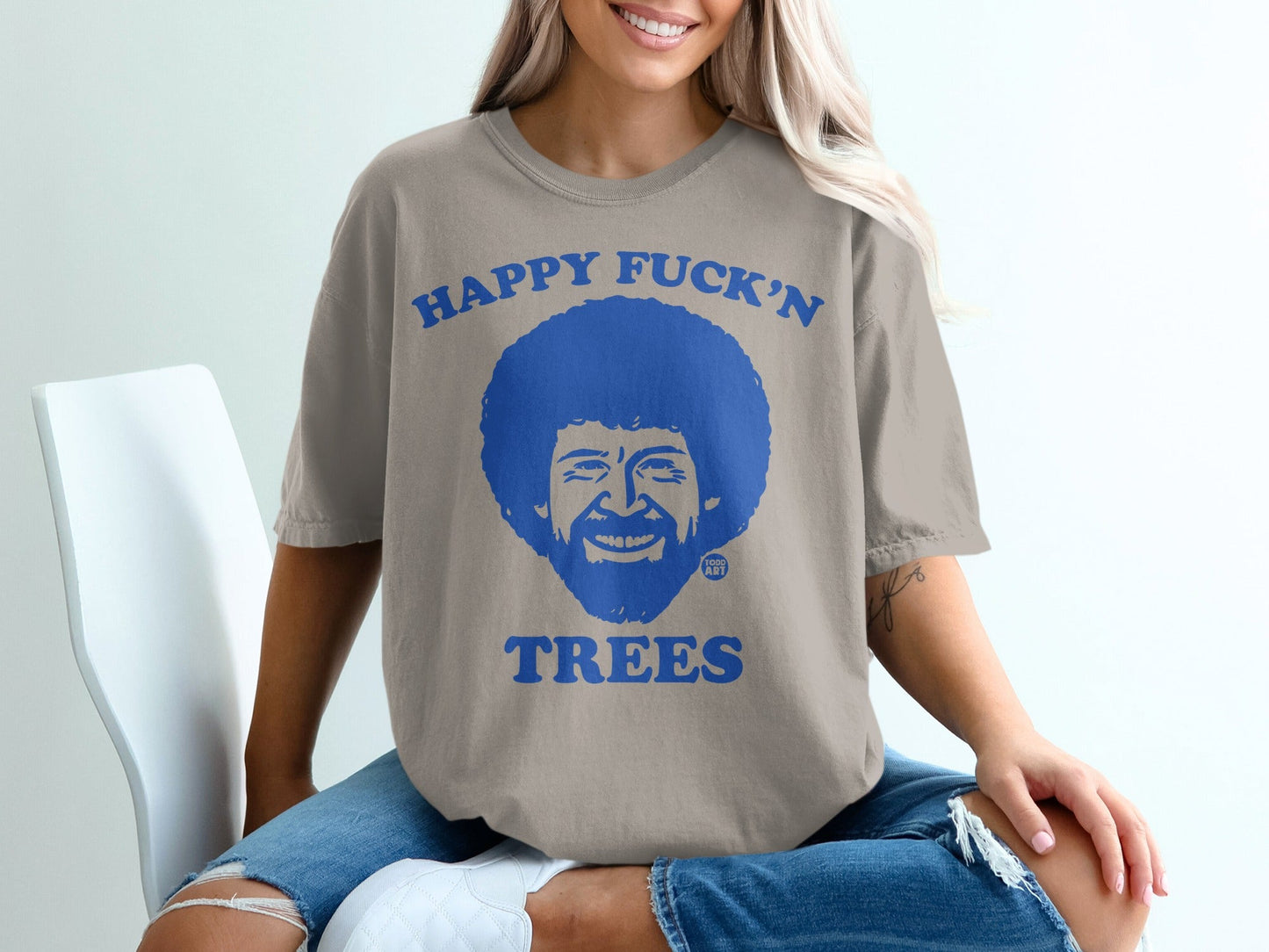 T-shirt with Bob Ross face and "Happy Fuck'n Trees" text.