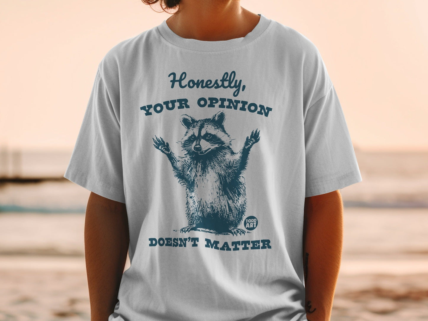 T-shirt with a raccoon graphic and the text "Honestly, Your Opinion Doesn't Matter."