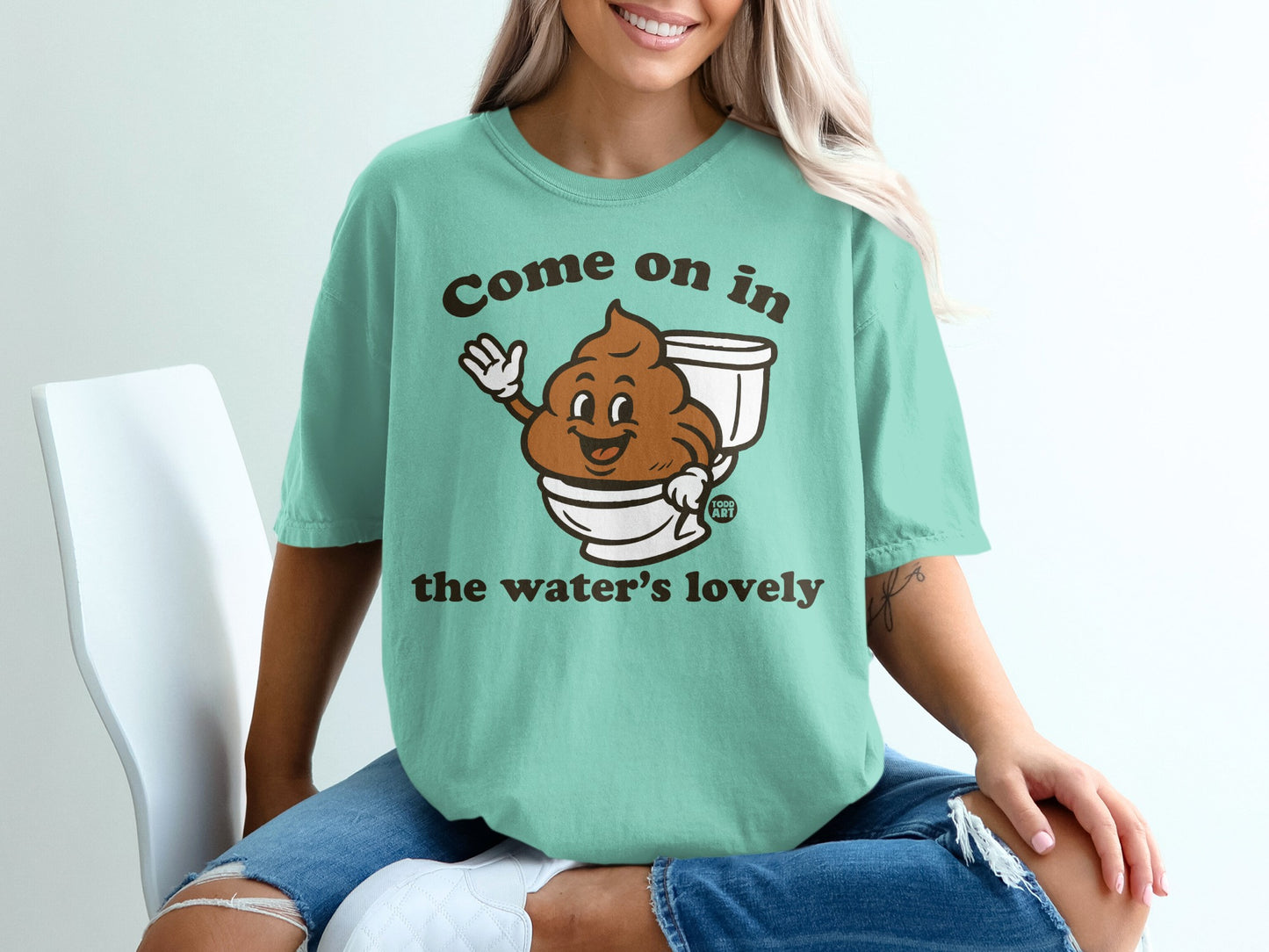 T-shirt with cartoon toilet and text "Come on in the water's lovely".