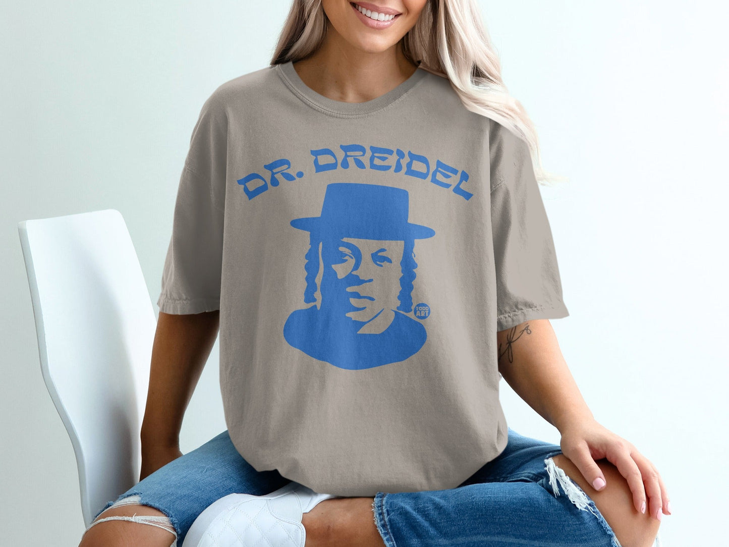 Dr. Dreidel graphic tee with blue text and portrait of a man.