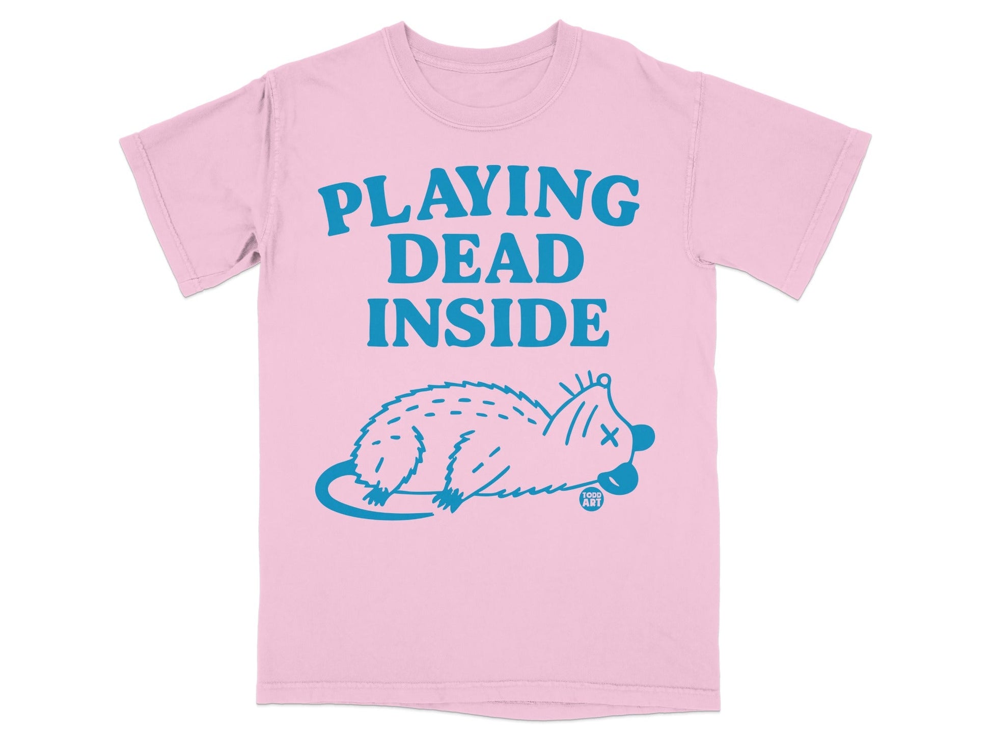 Pink t-shirt with blue text "PLAYING DEAD INSIDE" and a dead opossum illustration.