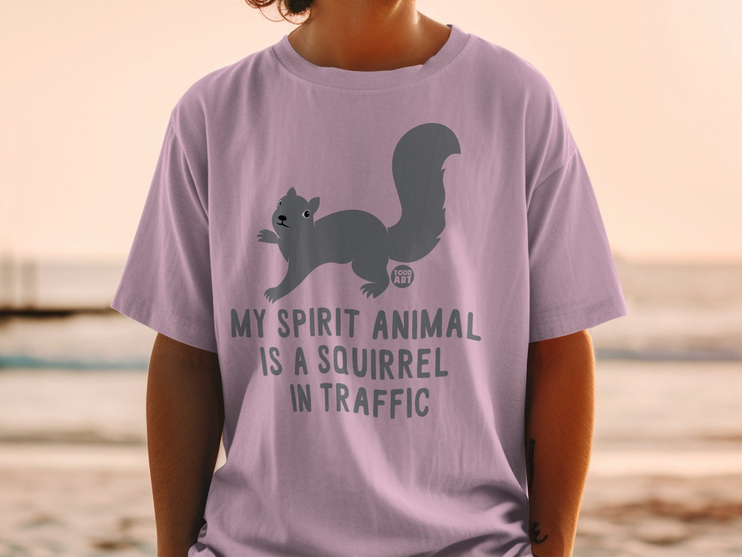 Lavender t-shirt with a gray squirrel graphic and "MY SPIRIT ANIMAL IS A SQUIRREL IN TRAFFIC" text.