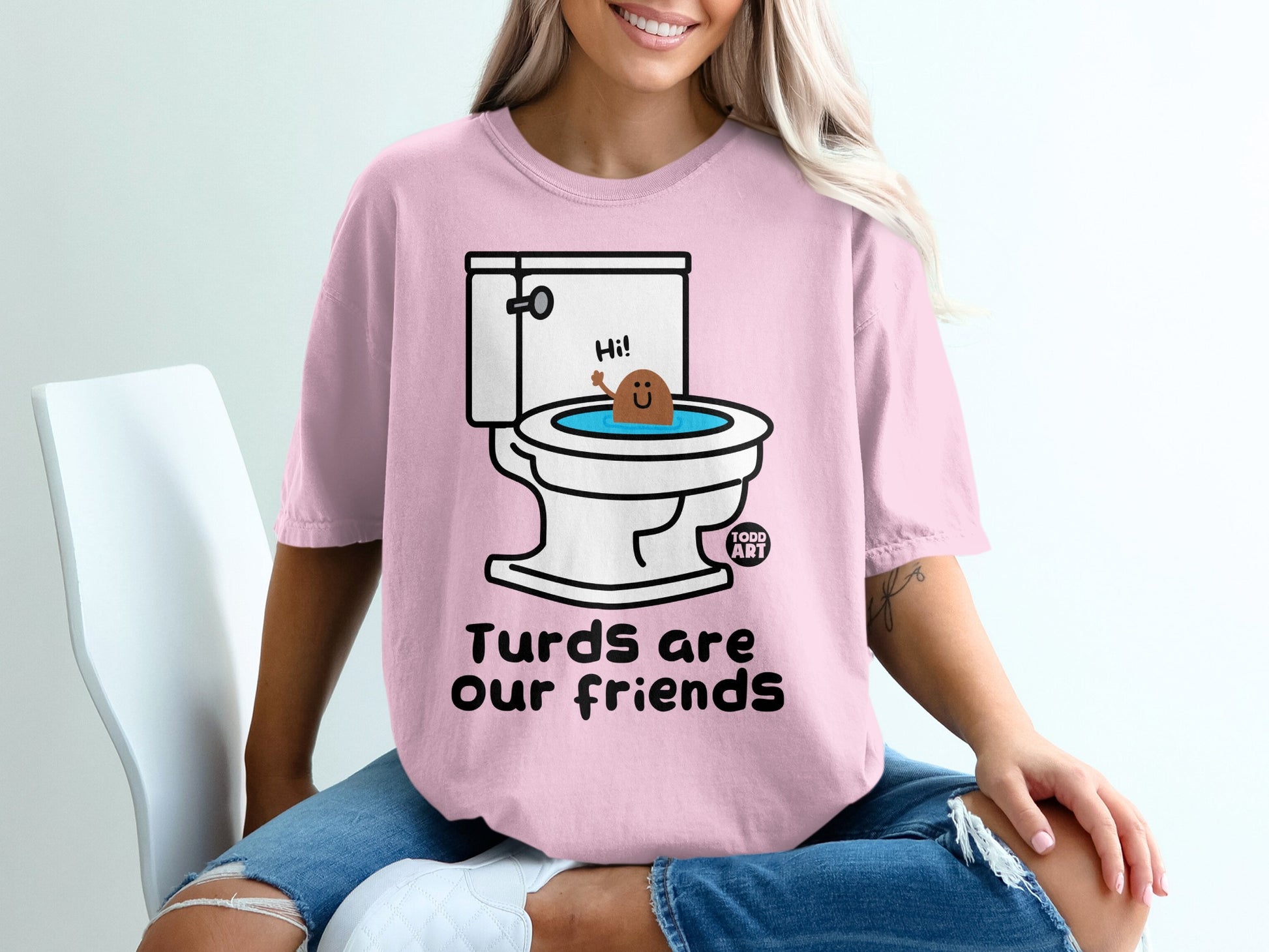 Pink t-shirt with toilet and smiling turd saying "Hi!"