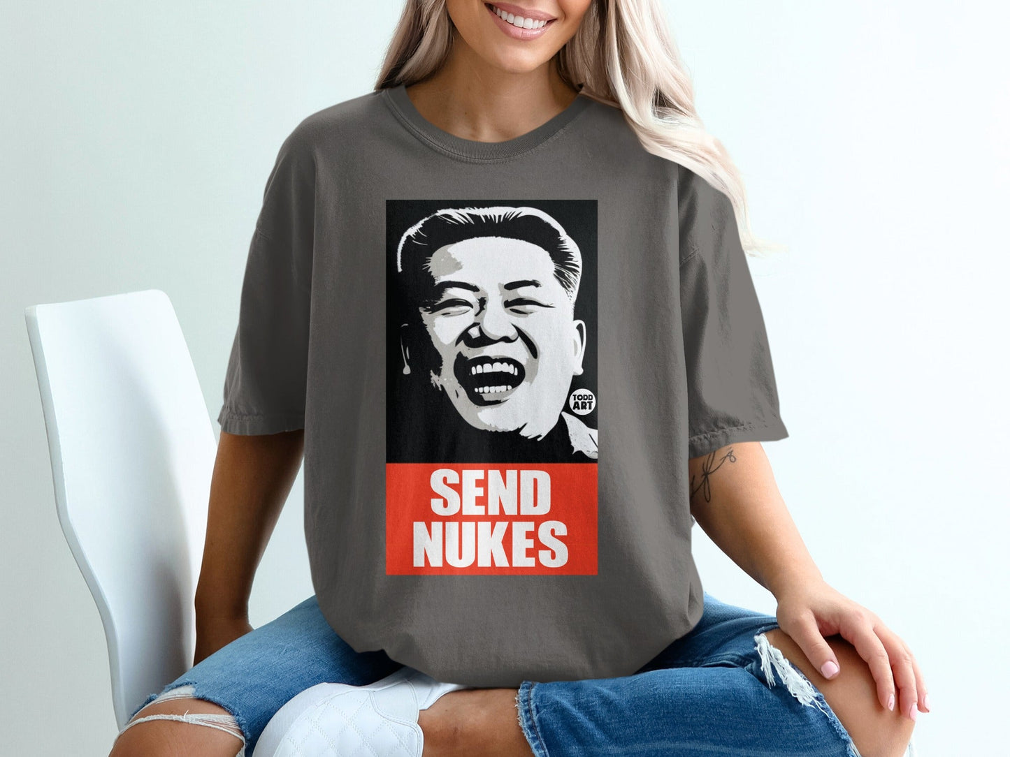 T-shirt featuring a caricature of Kim Jong Un with "SEND NUKES" text.