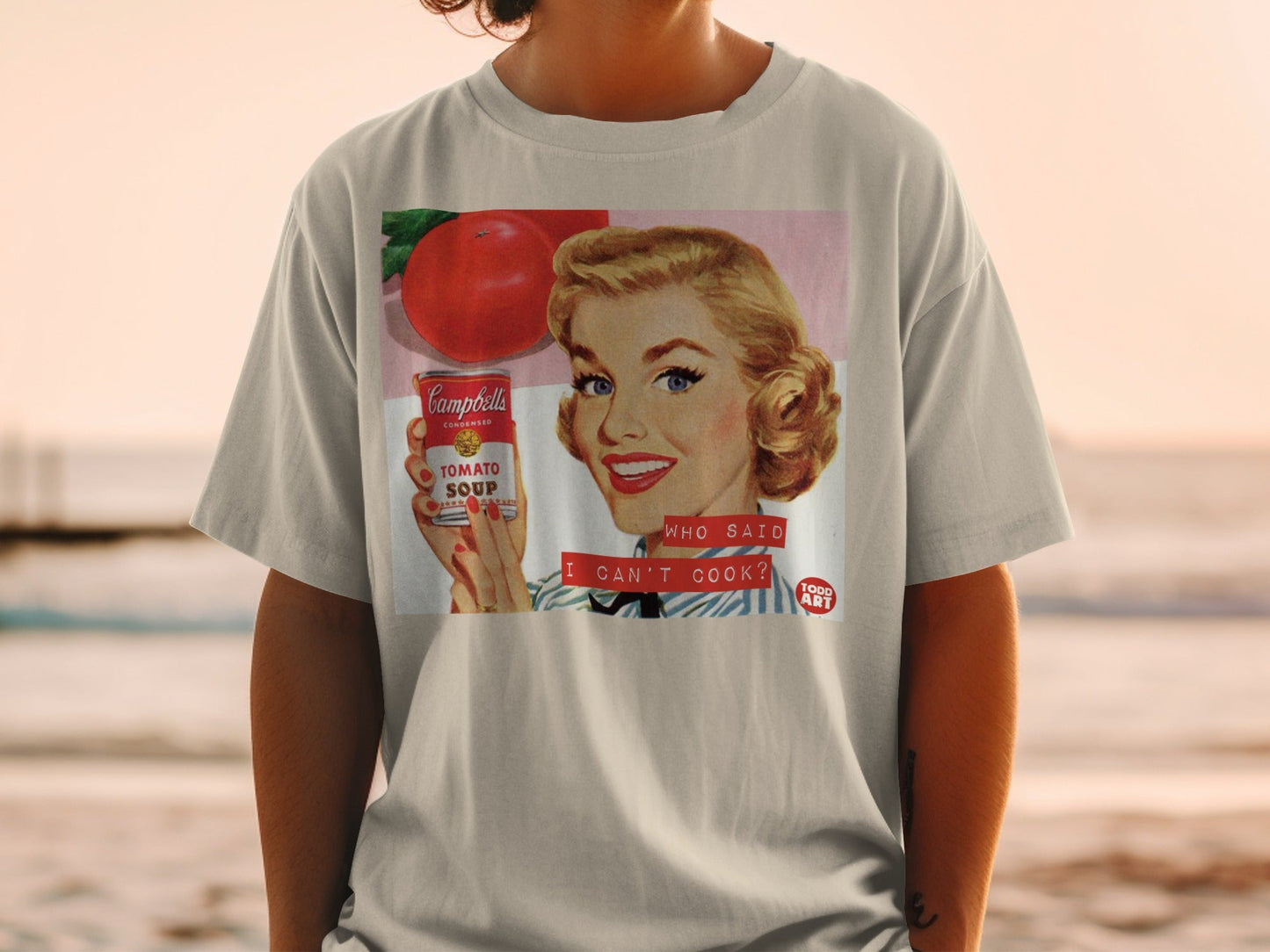 Woman holding Campbell's Tomato Soup can, says "WHO SAID I CAN'T COOK?".
