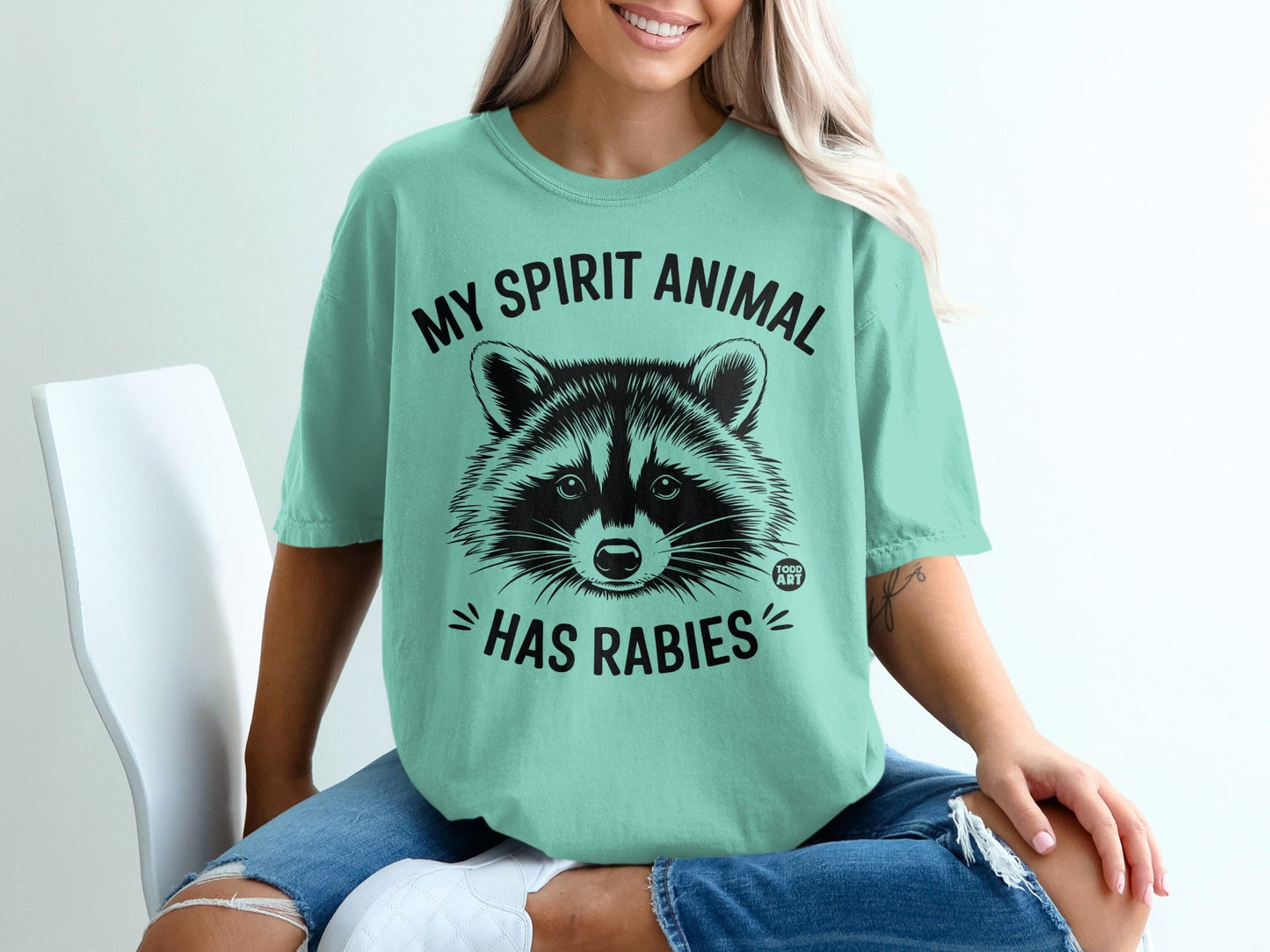 T-shirt with a raccoon graphic and "MY SPIRIT ANIMAL HAS RABIES" text.