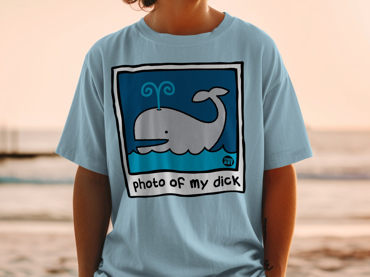Light blue t-shirt with cartoon whale and "photo of my dick" text.