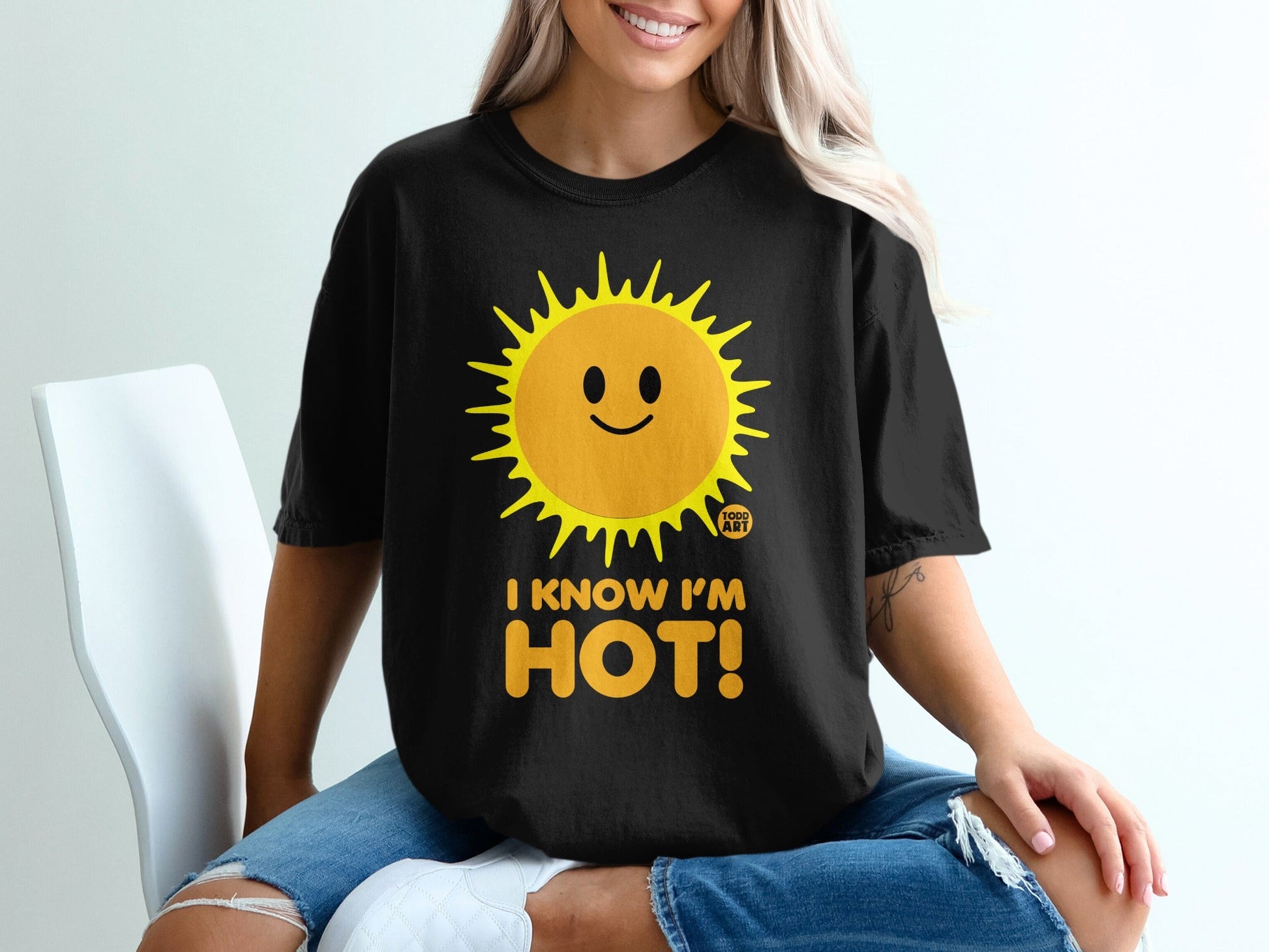 Black t-shirt with smiling sun graphic and "I KNOW I'M HOT!" text.