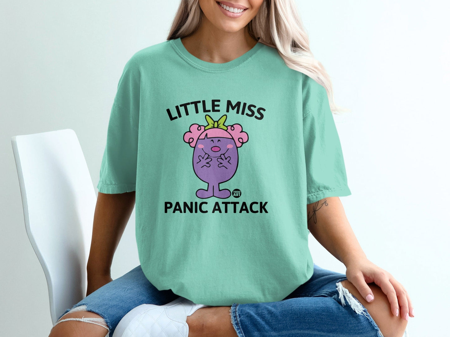 Mint green t-shirt with "Little Miss Panic Attack" cartoon character.