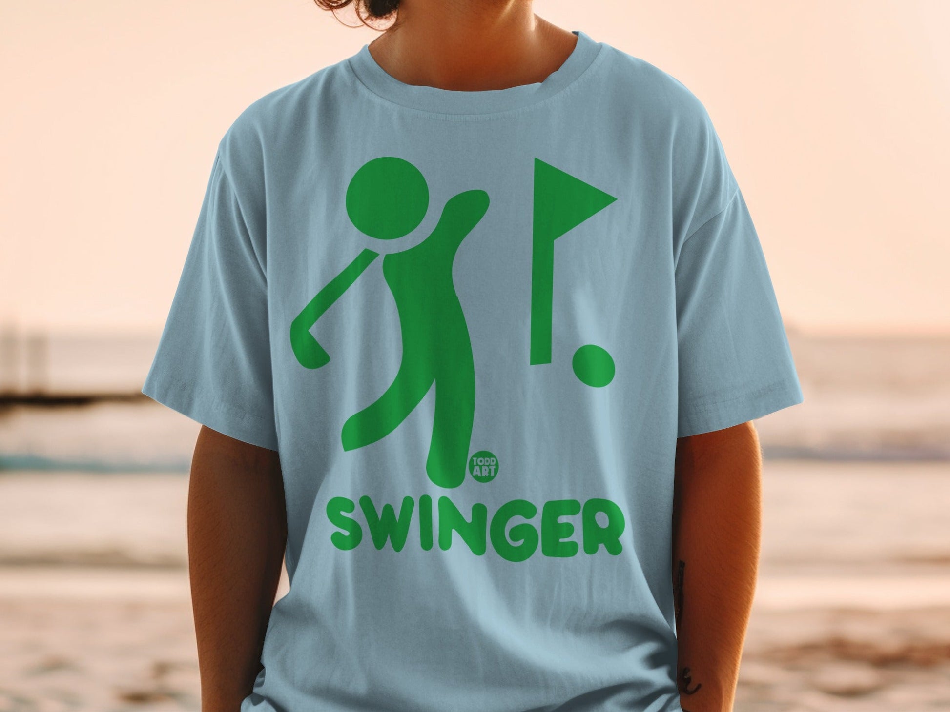 Light blue t-shirt with green golf graphic and "SWINGER" text.