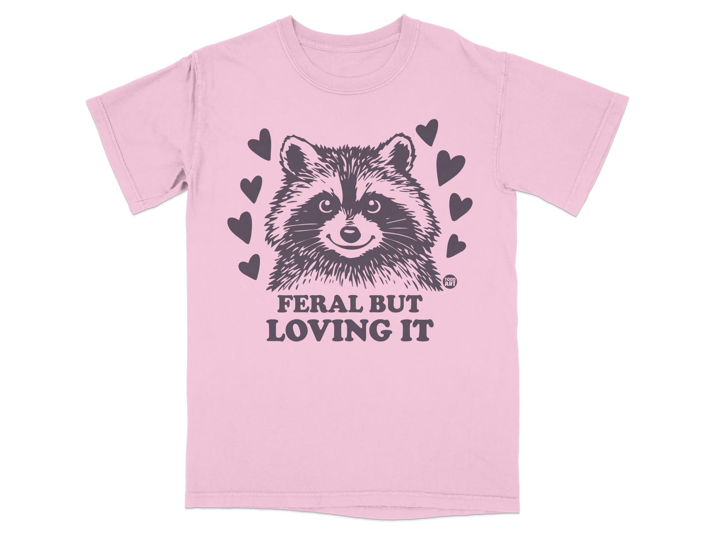 Pink t-shirt with raccoon graphic and "Feral But Loving It" text.