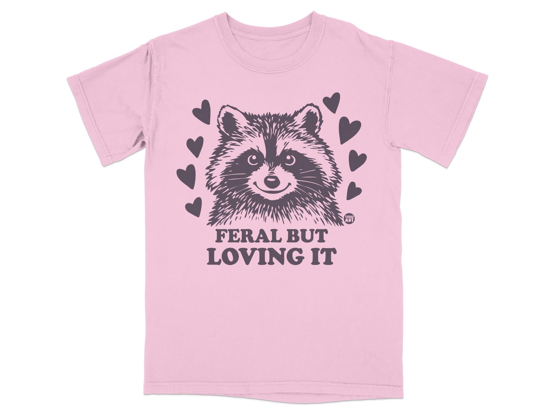 Pink t-shirt with raccoon graphic and "Feral But Loving It" text.
