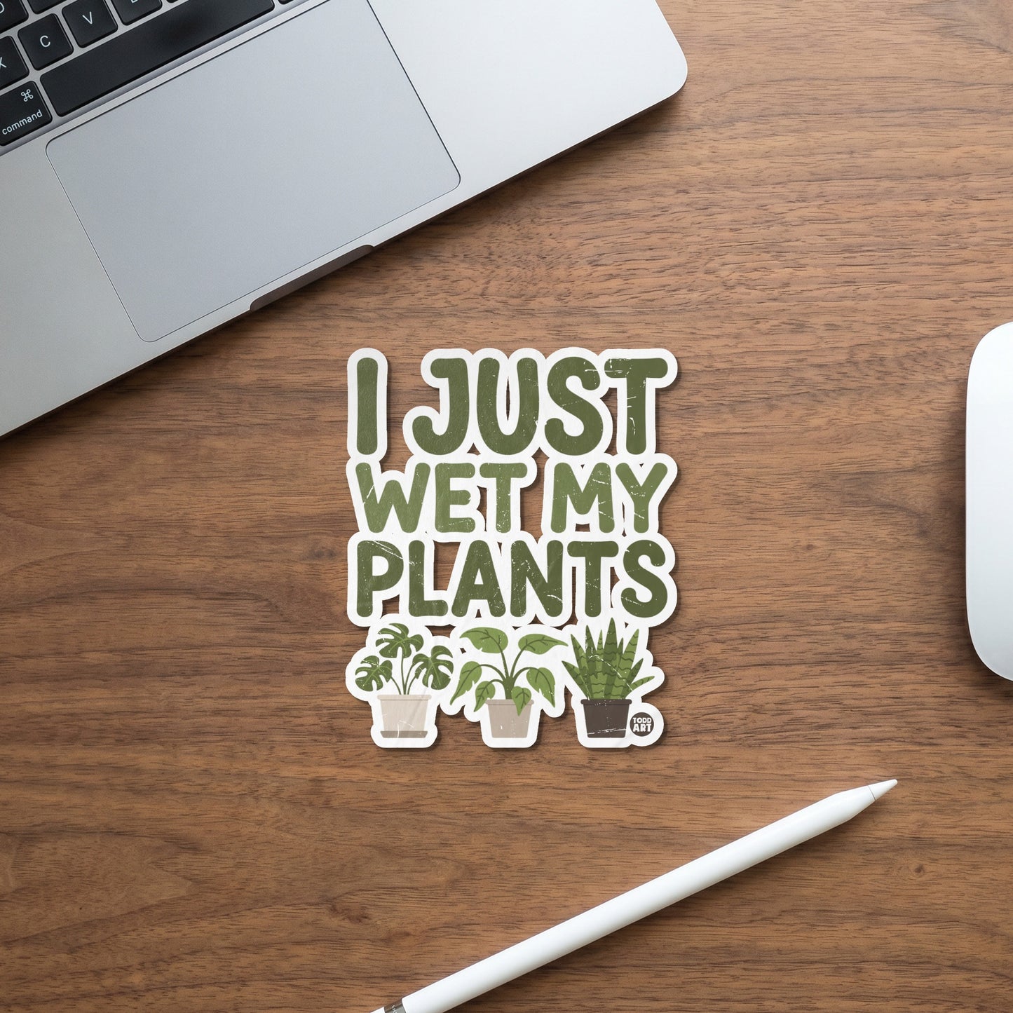 Green sticker with text "I JUST WET MY PLANTS" and three potted houseplants.