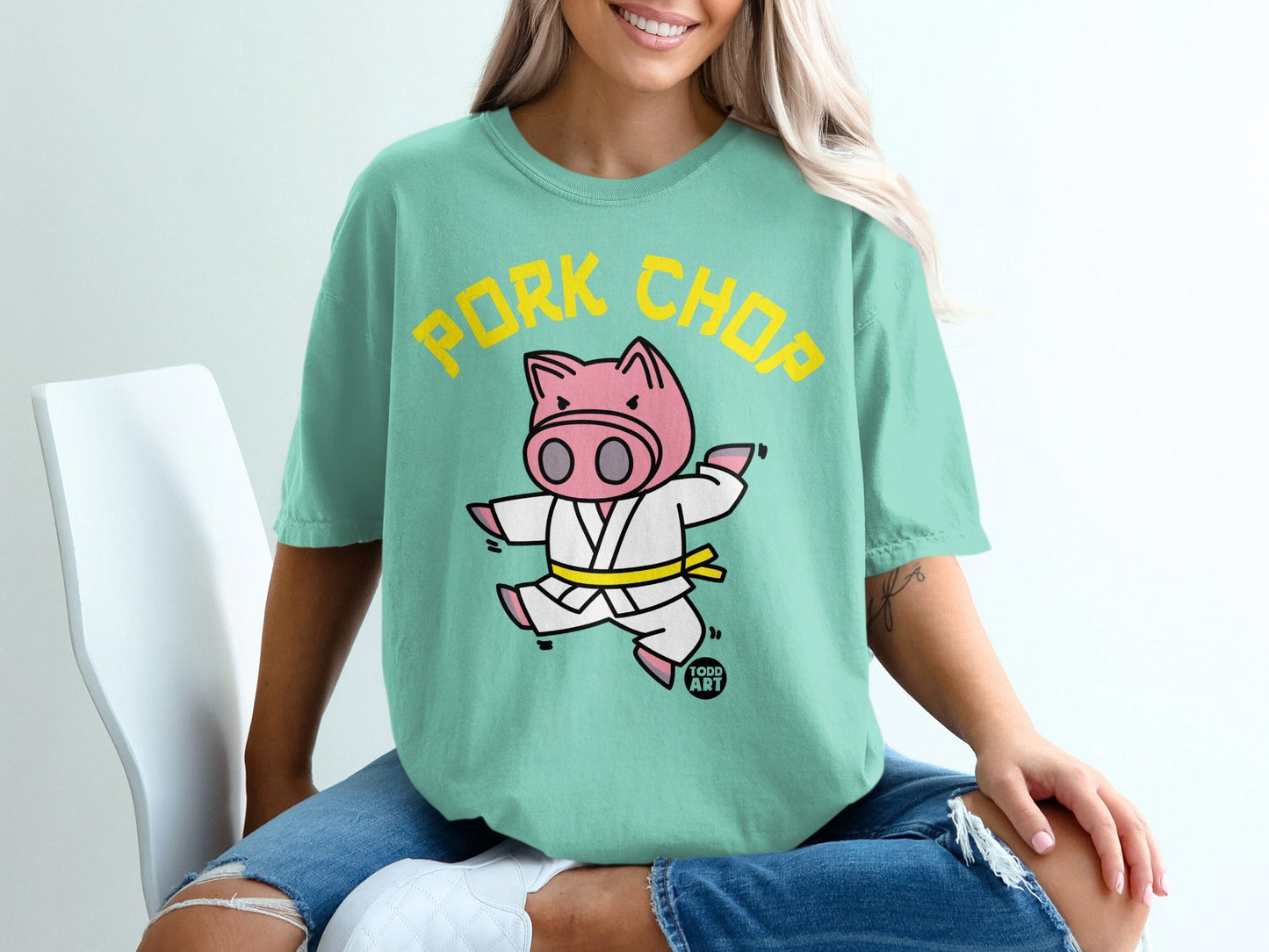 Green t-shirt with cartoon pig in a judo gi and "PORK CHOP" text.