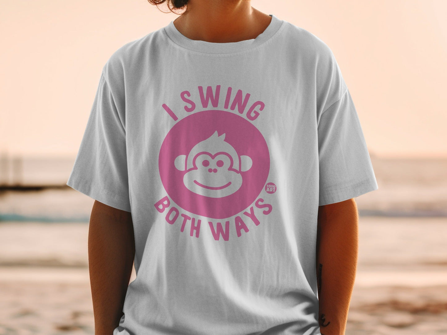 White t-shirt with pink "I Swing Both Ways" text and monkey graphic.