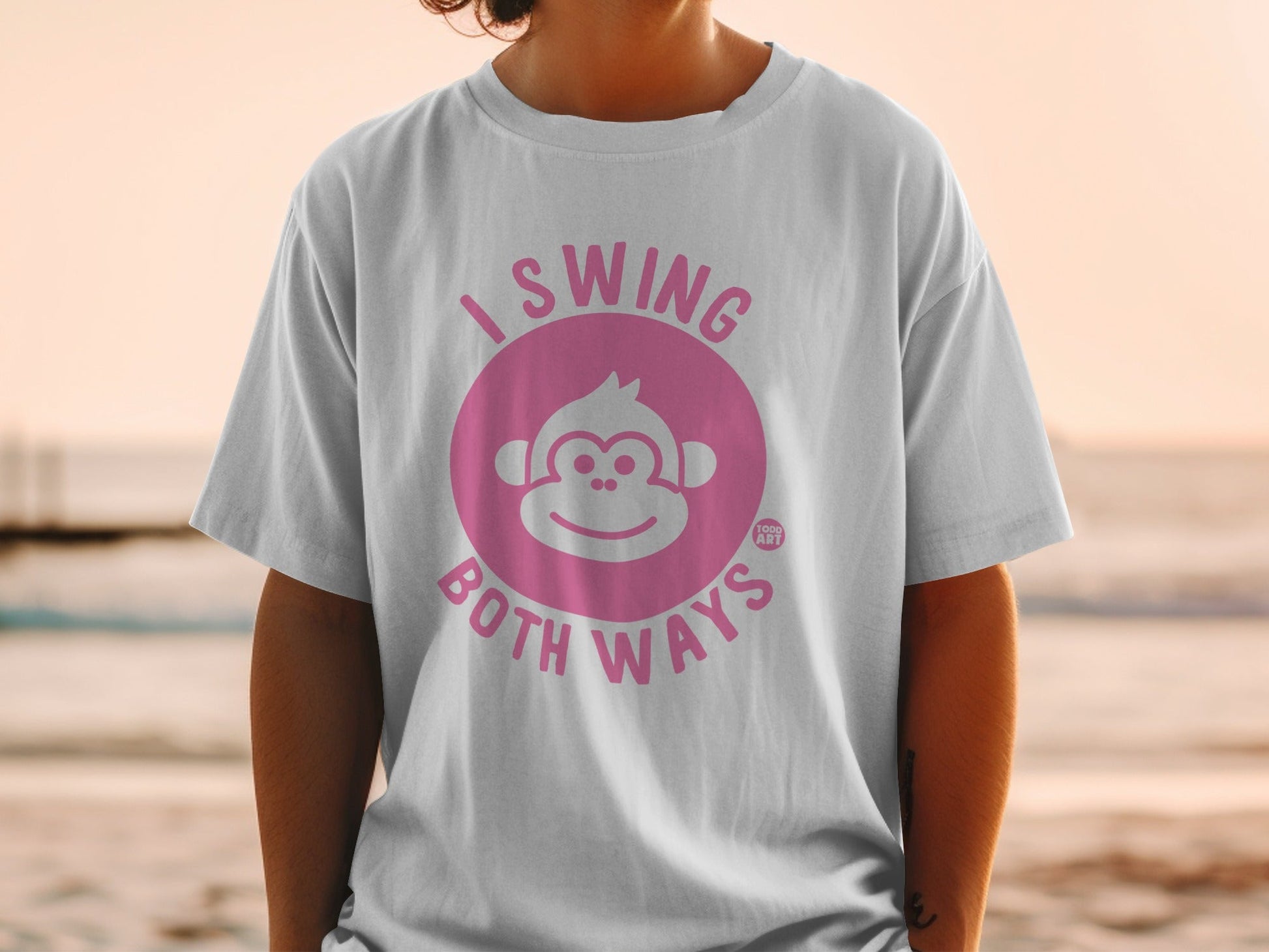White t-shirt with pink "I Swing Both Ways" text and monkey graphic.