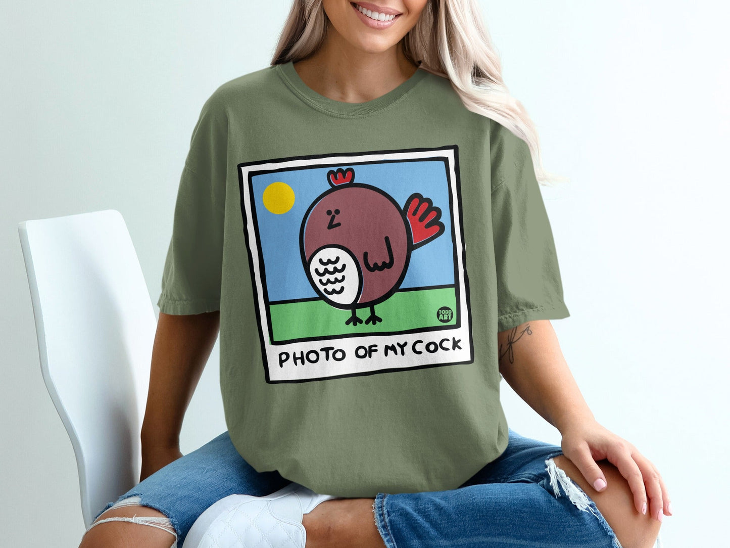 Green t-shirt with cartoon chicken and "PHOTO OF MY COCK" text.