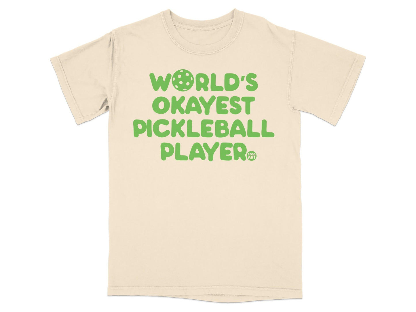Cream t-shirt with "WORLD'S OKAYEST PICKLEBALL PLAYER" in green text.