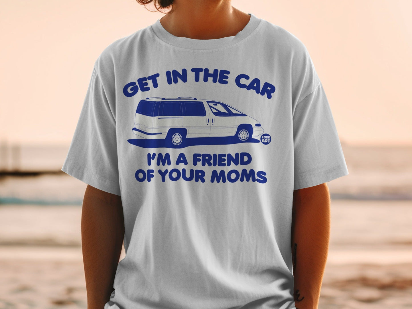 White t-shirt with blue text and illustration of a van reading "Get in the car I'm a friend of your moms".