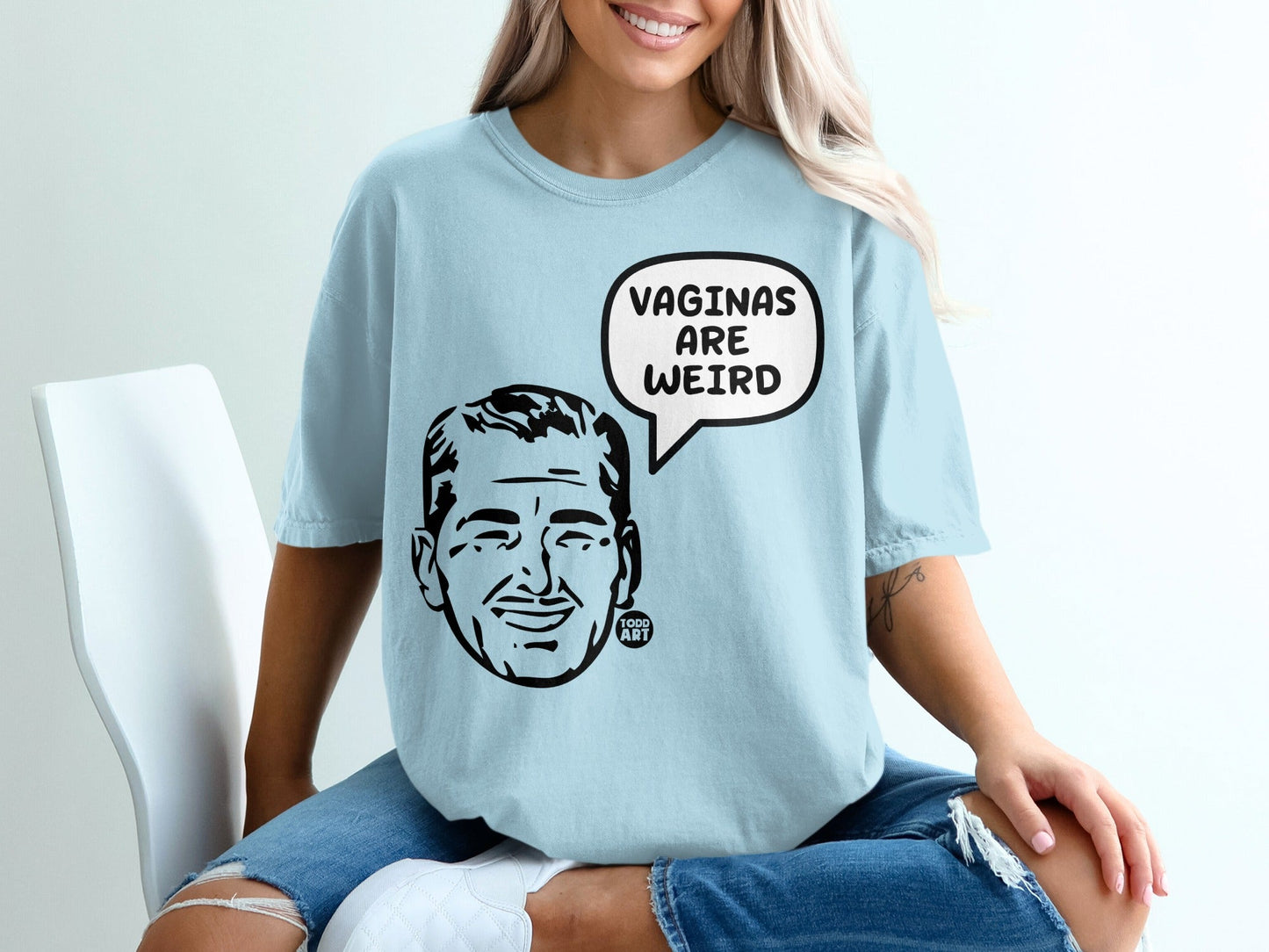 Light blue t-shirt with cartoon man saying "VAGINAS ARE WEIRD".