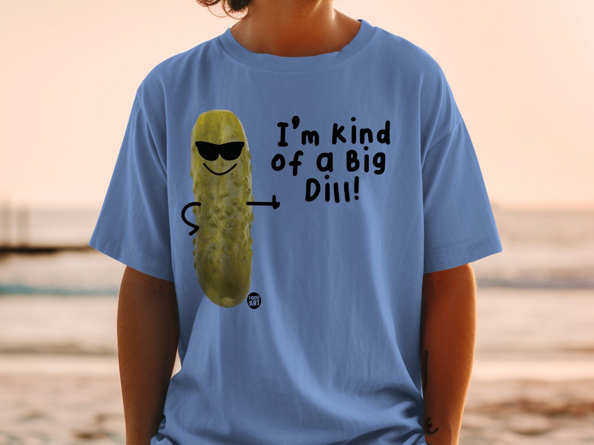 Blue t-shirt with a pickle character wearing sunglasses and the text "I'm kind of a Big Dill!".