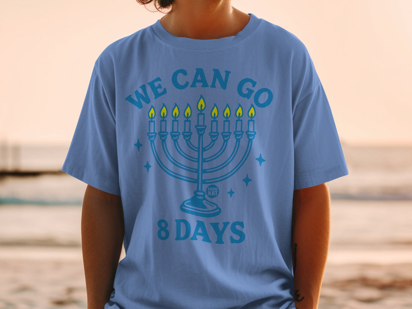 Blue t-shirt with a menorah and "WE CAN GO 8 DAYS" text.